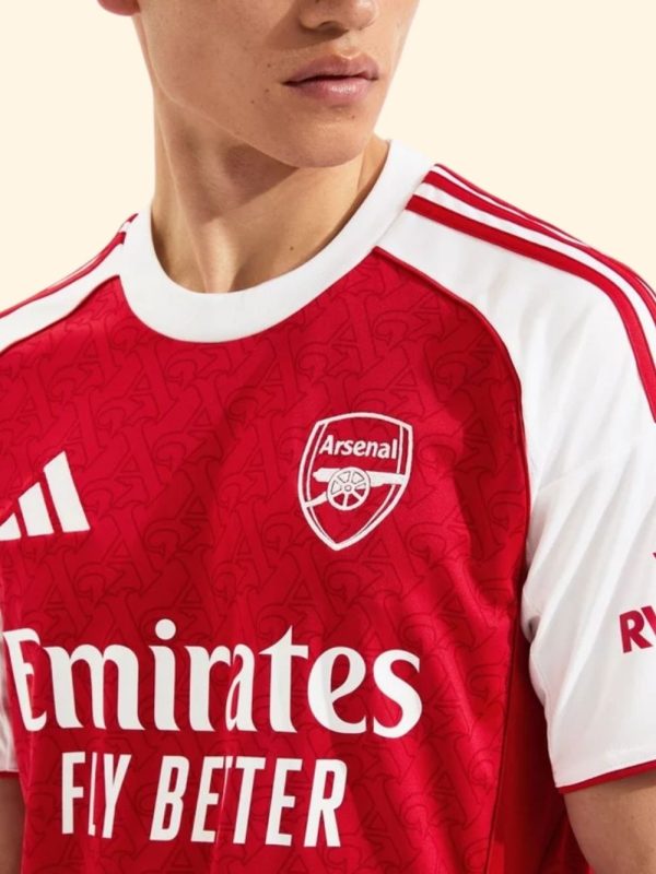 Arsenal 2025-26 jersey modeled in front of Emirates Stadium